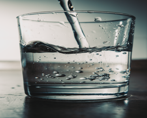 Water being poured into a clear glass